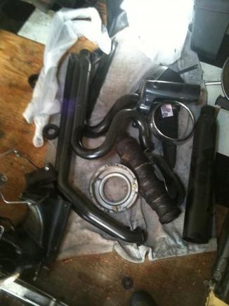 ok, the exhaust. d and d, fatcat. i got one on my other bike, and i was disappointing. the performance was out of this world. the fit and finish was perfect. the coating was all fucked up, and it pitted, and rusted in 11 months. see next pic. so, they sent me another one. and i put it on my bike. on the first one, D and D's welder showed up to work with his head on right, but, the coater was on crack. with the second pipe, the coater showed up to work with his head on straight, but, the welder had some serious issues. pipe fell off in colorado. the flanges stayed in the head, and the pipe broke off. so, for a $850 pipe, i had to spend 20-30 hours, and several hundred dollars to make it right. this is my fix for the first pipe. sent it to my powder coater. is is on my scoot now, and it is perfect.