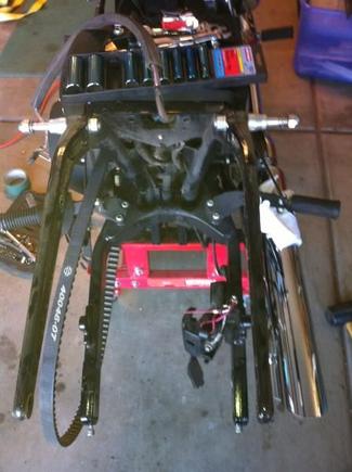 Rear fender off. Wiring conduit is draped over the socket set. I used a heat gun and gently pulled and it came right off.