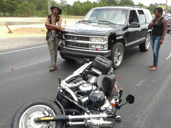 The lady in black, standing by her sister's Tahoe, slammed into me while I was stopped at an intersection.  I was about the 5th vehicle in line at the red light.  She said she looked up and saw the light turn green and hit the gas.  "I didn't see you at all," she said.  I was wearing an orange Harley safety vest.