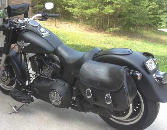 Windshield with pouch is handy, but I prefer the look of removing the windshield and using a fork bag above the headlight. Keeps the bike looking low, mean and fat.