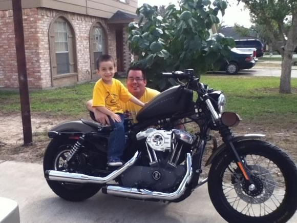 My son and I and my Harley Nightster.