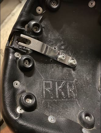 Modified the seat tab by cutting off the 'loop' and moved it 'in' by adding an additional mounting hole in the pan. This places the slot directly over the existing nut in the fender.