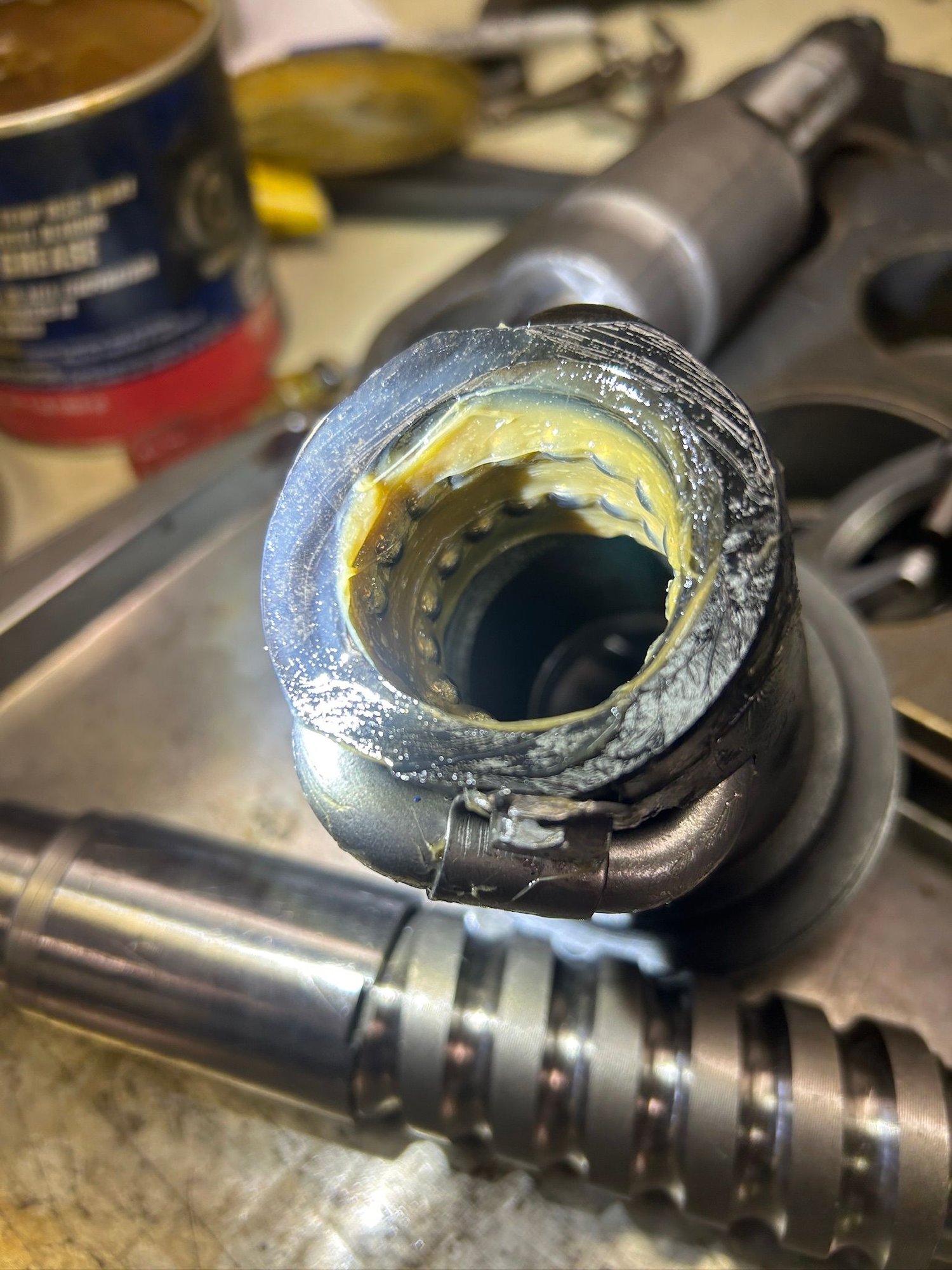 The ball bearings are held to the inside of the piston by grease