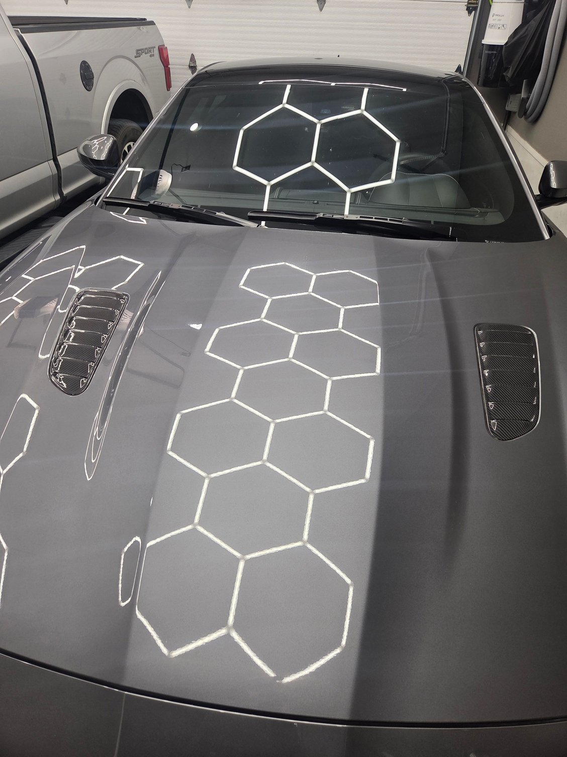 Carbon fiber hood vents from Mina Gallery. I made custom brackets to install them vs double sided tape.