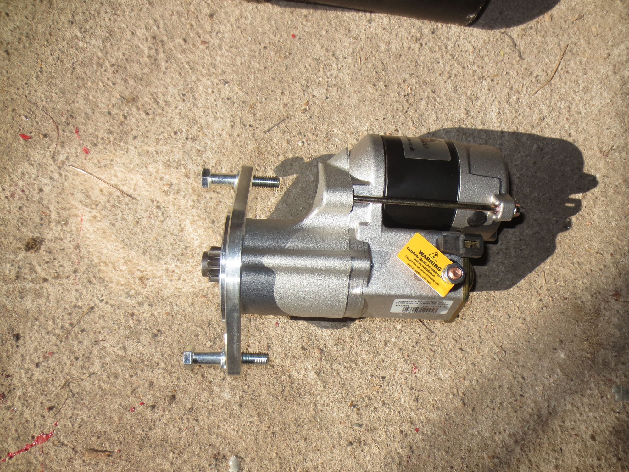 Closeup of new starter. It may be that the heatshield above the starter has to be modified to clear the more bulky top part