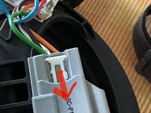 Release by pushing forward the locking tabs on both side and remove white plastic bit completely. Remember to reinstall later