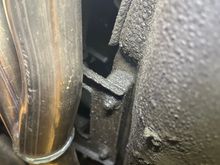 the right end behind the exhaust