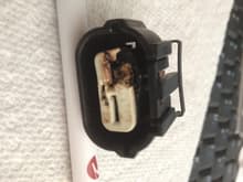 Burnt connector (melted) from right side of battery. Not connected to anything, as far as I can determine. Two wires. Disconnected battery. Cut wires, taped over. Wires are Brown-Red (or Brown-Orange) and Brown-White (or Brown-Yellow). Really suspect.