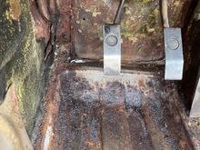 rust just above floor pan to left of clutch pedal