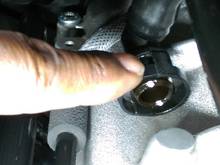 The best way to remove this  tube is to release it from the throttle body, then while pushing it back, release the squeeze couple by pressing on one side at a time.