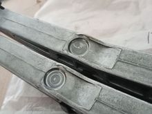 Wear from the plunger is elongated by about 0.5mm. Due to the 60 degree angle with the pivot point the plunger must slide. As the hole wears deeper I think the plunger movement will become impeded. 
The tensioners must be able move continuously to allow the relatively different rates of thermal expansion between the aluminium engine and steel timing components. 