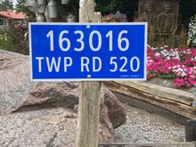 Destination roadsign with the memorial garden being designated in the background.