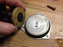 Backside of impeller in my hand shown and worn spot on separation plate.