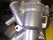 Alloy Thermostat Housing. The plastic one is OK too. But the seal is questionable!