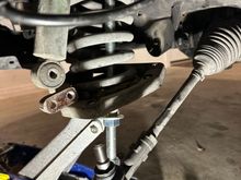 Here's a (so-so) pic of the tool in place within the spring, holding the front part of the lower control arm/plate in place. The jack was "there" but not actually doing anything.