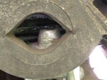 Jack top under frame behind bump stop.