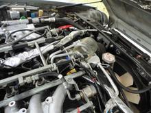A1 injector pointed into a glass jar to test for spray while turning over the engine. Fuel does spray into the jar.