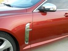 Chrome side vents and mirrors plus pinstripe.