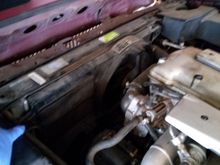 A bolt at the top corners hold the assembly in place.  The bottom sits in a slot.