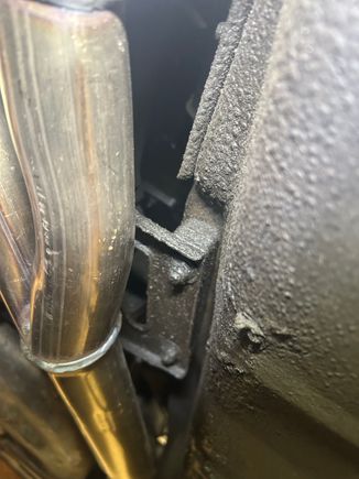 the right end behind the exhaust