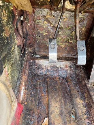 rust just above floor pan to left of clutch pedal