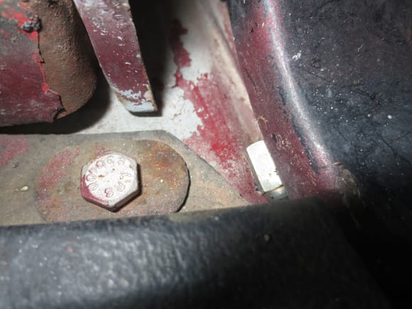 Tiny nut blocking the hinge edge where it overlaps the fixed part bolted to the car