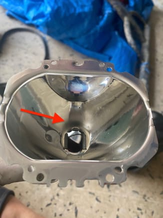 Driver's side reflector bowl: The arrow points to a dull area. When reinstalling, I flipped this so that the light being projected to the road is from the non-burnt reflective end. 