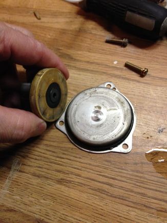 Backside of impeller in my hand shown and worn spot on separation plate.