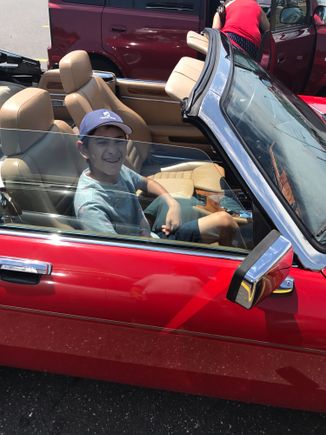 A very happy 14 year old getting into "his" car.
