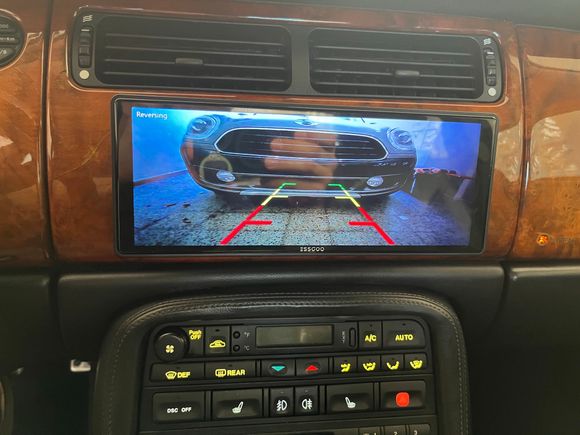 Reverse camera (it activates automatically when the gear lever is in reverse). I tapped into the reverse bulb wire at the passenger side (US) tail-light harness (yellow wire). 