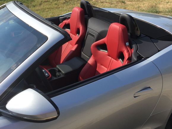 Interior shots.  I thought the red interior made the car stand out a little more than black.  Maybe a little silly - but I had the cat logo on the grill and center pieces on wheels put in as red also.  I think it makes all our cars have a unique look for each owner.