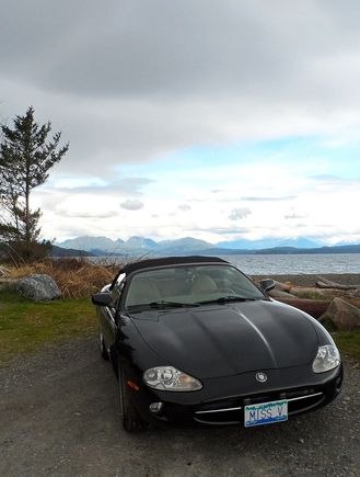 Miss V at Rebecca Spit with the Coastal Range on mainland Canada behind along with a number of islands.