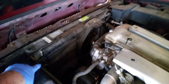 A bolt at the top corners hold the assembly in place.  The bottom sits in a slot.