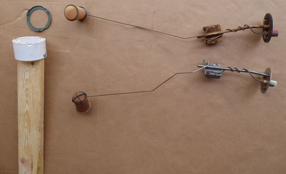 Top ( red ) is uncleaned left, bottom ( white ) cleaned, both with bad floats. Custom tool for lock rings to left.