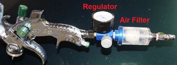 The green regulator knob on the bottom of the gun always remains fully open. Adjust the regulator know to about 25 psi. And use an air filter, plus before spraying, purge the oily water in your air-compressor.