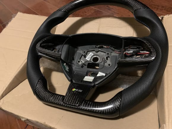 CF trim around your steering wheel controls. This is a rare item. Most other wheels that I have found at the time did not include this.