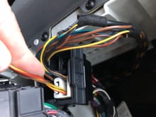 This is my car.  The mysterious brown/yellow and red/yellow wire runs into the iPod wiring harness. The other end, picture above is not plugged into anything. 