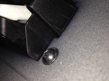 Screw inside trunk next to right side of latch