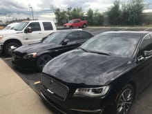 cloudy, w205 35% around and 50% windshield next to new Lincoln continental with factory privacy glass and factory tinted windshield.