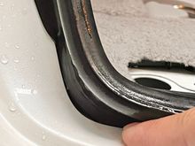 Notice the weatherstrip angles and tucks into this panel gap, leaving a gap for water to get in. This is how it was installed. 