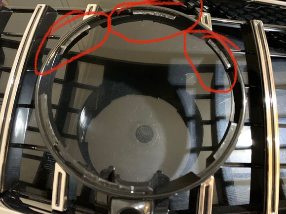 These areas needed to be trimmed to flush fit the emblem. It was an imperfection with the moulding with raised areas and being too deep overall.