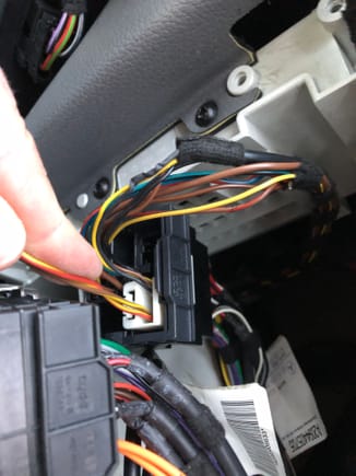 This is my car.  The mysterious brown/yellow and red/yellow wire runs into the iPod wiring harness. The other end, picture above is not plugged into anything. 