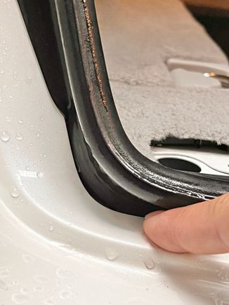 Notice the weatherstrip angles and tucks into this panel gap, leaving a gap for water to get in. This is how it was installed. 
