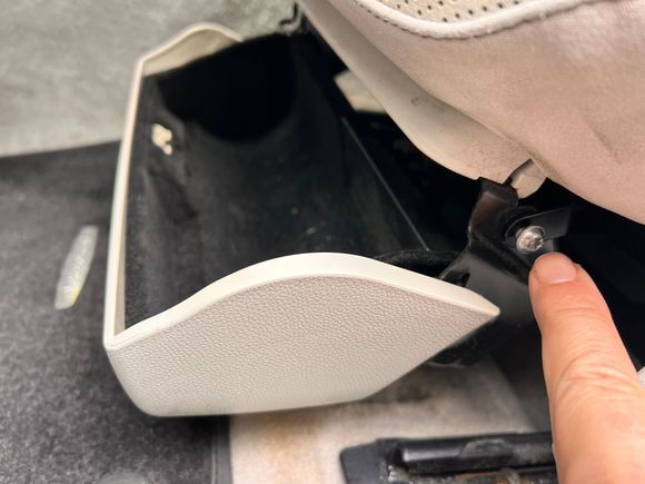 Start by removing the storage bin under the seat. There are two screws. One on each side. Easy to see if you open the bin. Here’s the outer screw. 