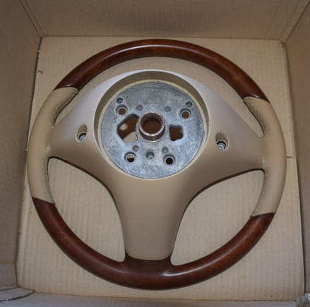 The backside of a 2008 Mercedes SL R230 wooden steering wheel