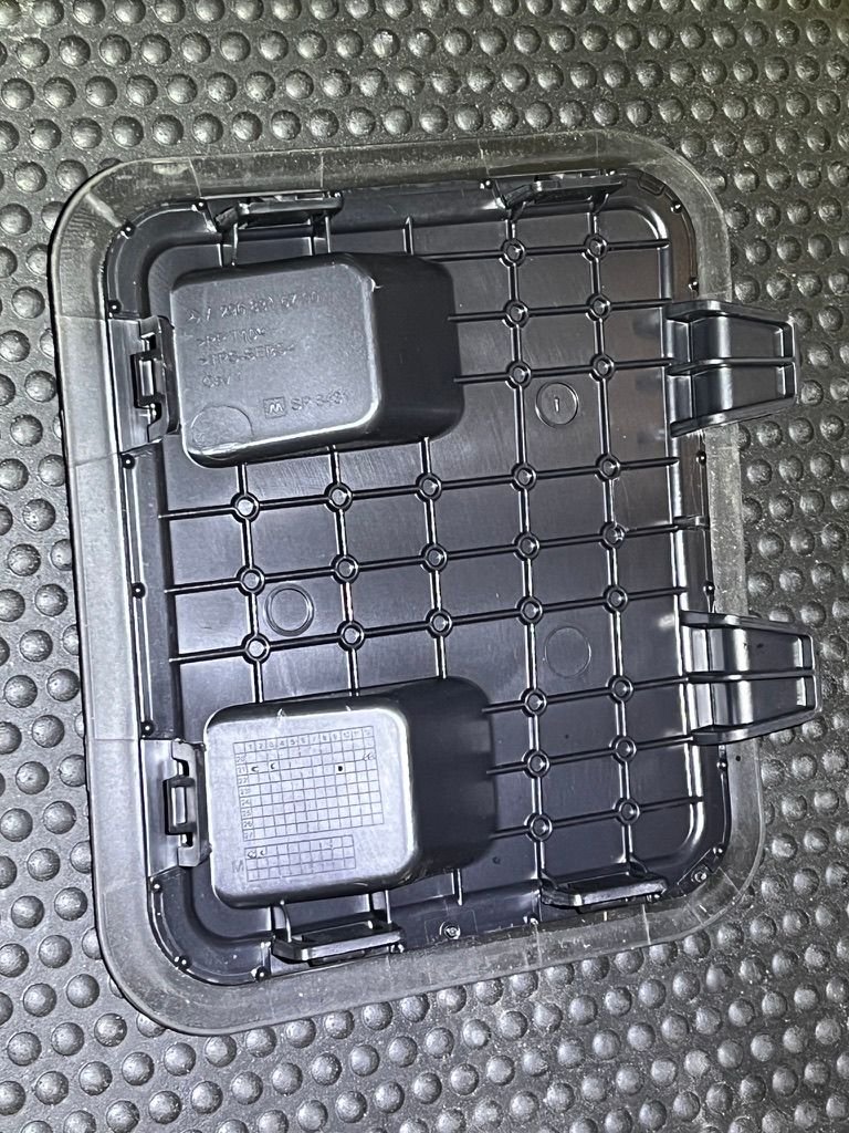 Bottom side of cover showing tabs on rear edge.