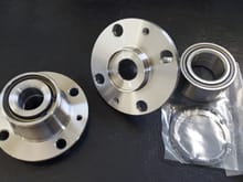 Front and rear hubs, sans studs.  Tapered Roller Bearing.