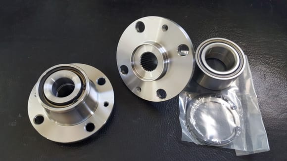 Front and rear hubs, sans studs.  Tapered Roller Bearing.
