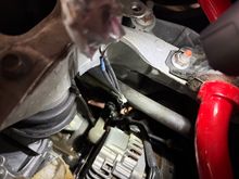 From the sandwich plate, run the sensor harnesses up along the lines running alongside the alternator.