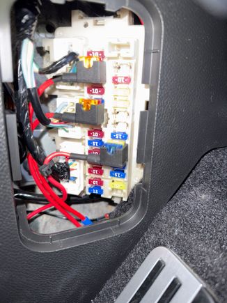 Drive’s side fuse box connections (mentioned earlier in the thread). Note that the ground you want to use is just below the fuse box. You will need a crimped terminal connection on the ground. Loosen the 10mm bolt, slip the connection on then tighten. 